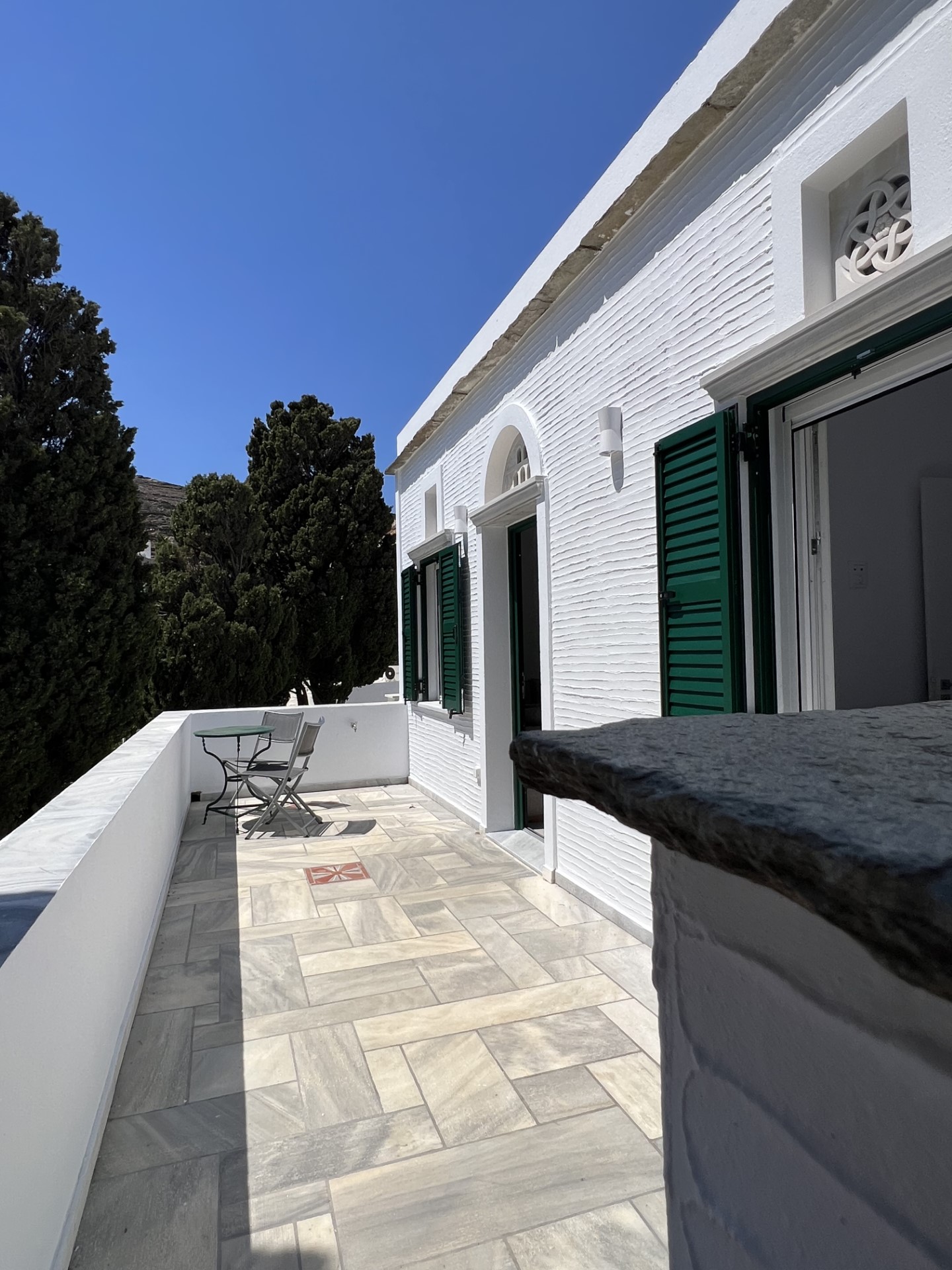Terrace entrance with marble and green shutters