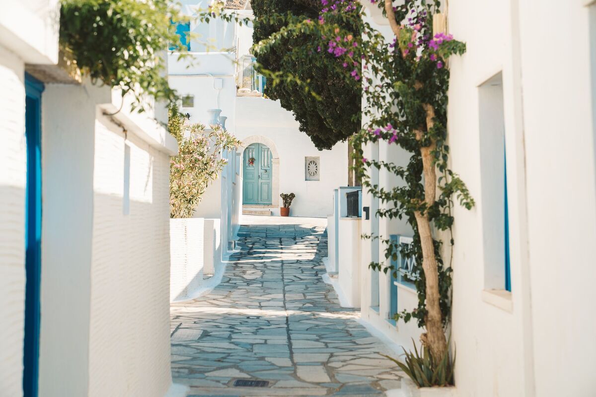 Pyrgos village in Tinos — white houses cascading down a hillside at dusk