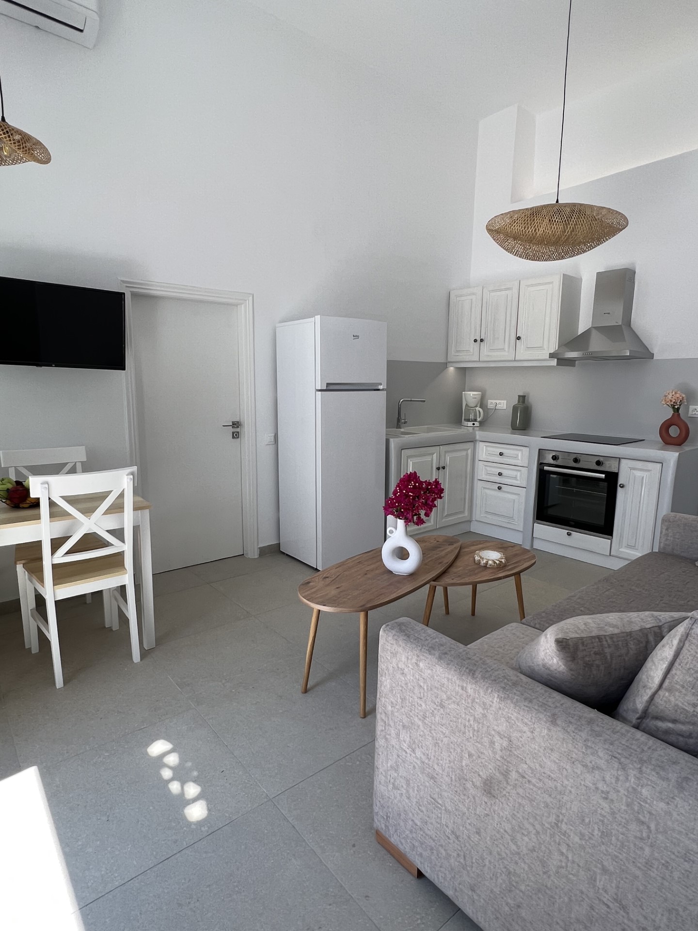 Sirocco suite — bright living space with kitchen and woven pendant lights